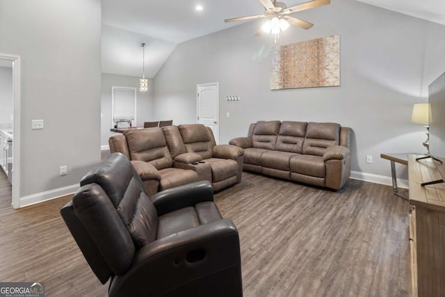 living area featuring lofted ceiling, a ceiling fan, baseboards, and wood finished floors