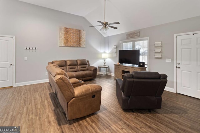 living room featuring ceiling fan, baseboards, vaulted ceiling, and wood finished floors