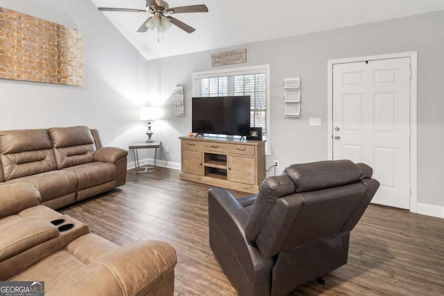 living area featuring lofted ceiling, ceiling fan, wood finished floors, and baseboards