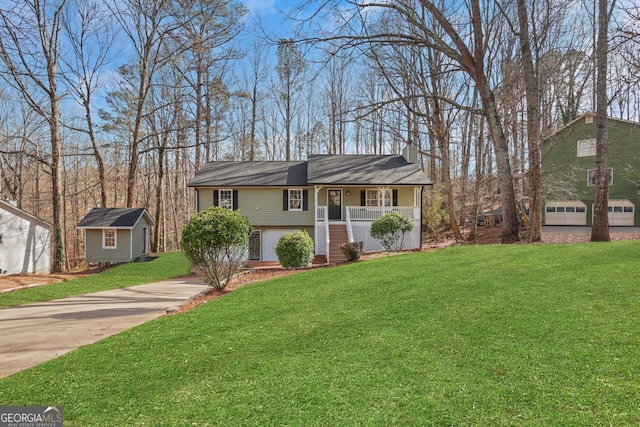 view of front of house with driveway, covered porch, an outdoor structure, and a front lawn