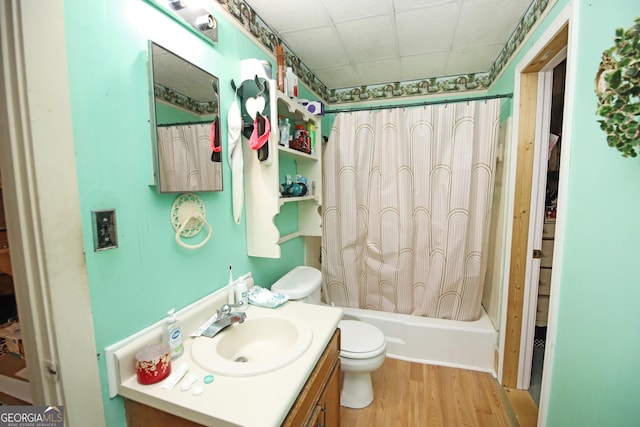 full bathroom with toilet, shower / tub combo with curtain, wood finished floors, and vanity