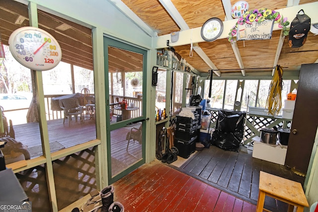 sunroom featuring lofted ceiling and wooden ceiling