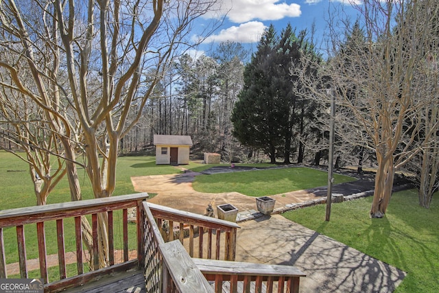 view of yard with an outbuilding, a patio area, and a shed