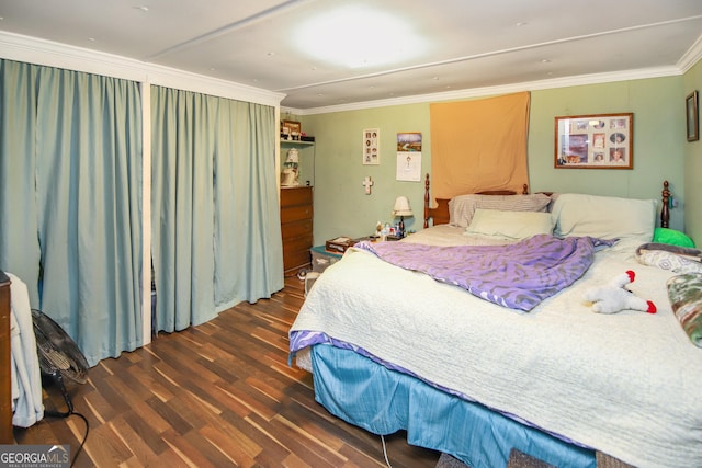 bedroom with wood finished floors and crown molding