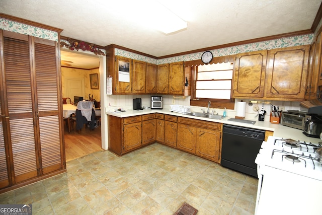 kitchen featuring black dishwasher, light countertops, gas range gas stove, and a sink