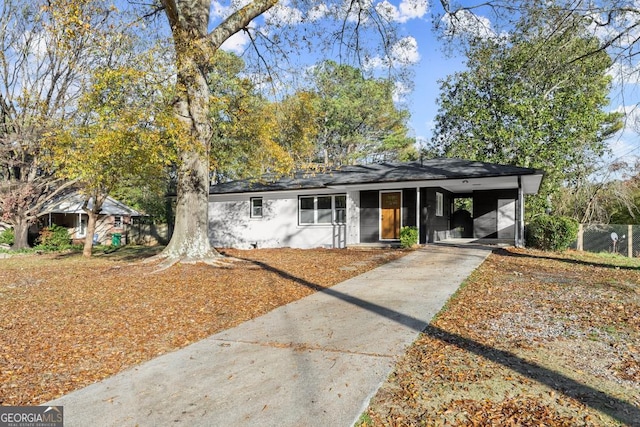 view of front facade with a carport and concrete driveway