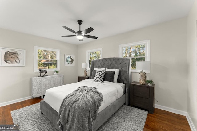 bedroom featuring ceiling fan, baseboards, and wood finished floors