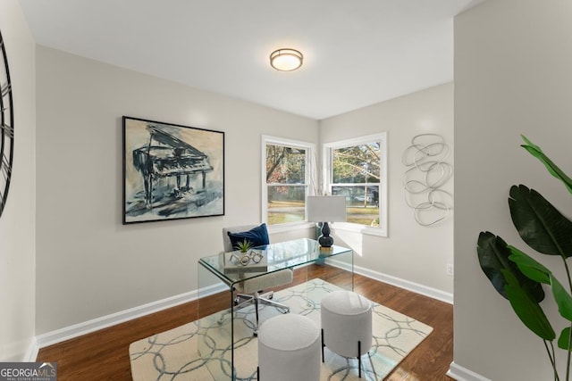 office space with baseboards and wood finished floors