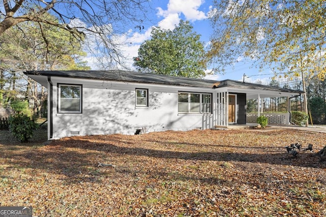 ranch-style home with a carport, driveway, and crawl space