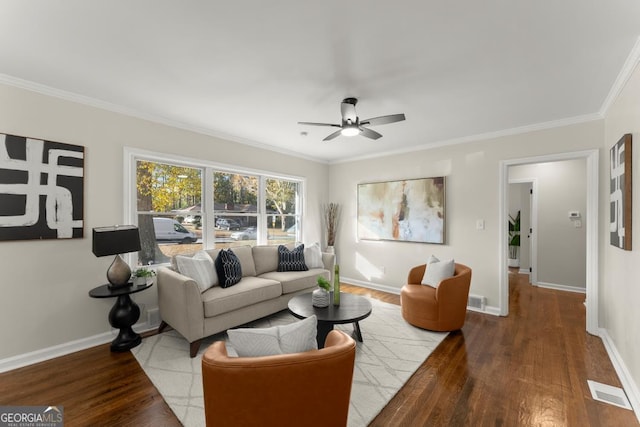 living area featuring ornamental molding, a ceiling fan, baseboards, and wood finished floors