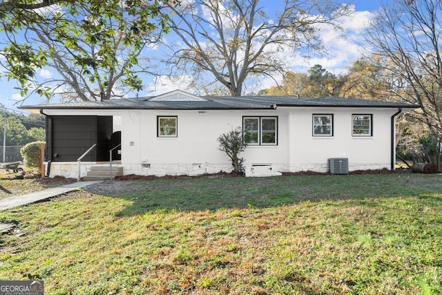 exterior space with a front lawn, central air condition unit, and crawl space