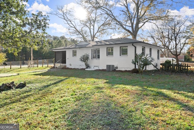 exterior space with fence, central AC, a yard, a sunroom, and crawl space