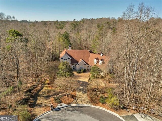 bird's eye view featuring a wooded view