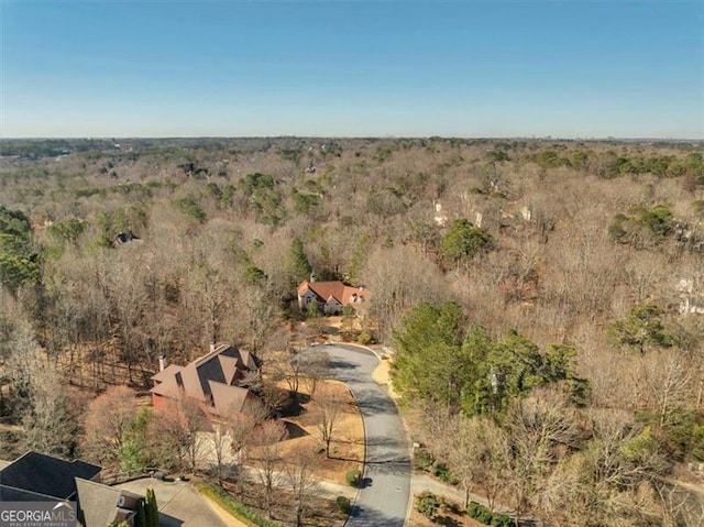 drone / aerial view featuring a wooded view