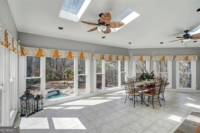 sunroom with a skylight and a ceiling fan