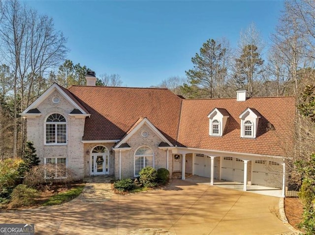 3460 Mansions Pkwy, Berkeley Lake, GA 30096 - view of front facade with concrete driveway, a chimney, and brick siding