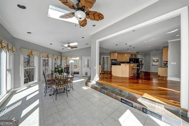 interior space featuring lofted ceiling, light tile patterned floors, and ornamental molding