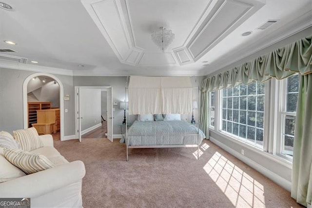 carpeted bedroom with arched walkways, visible vents, crown molding, and baseboards