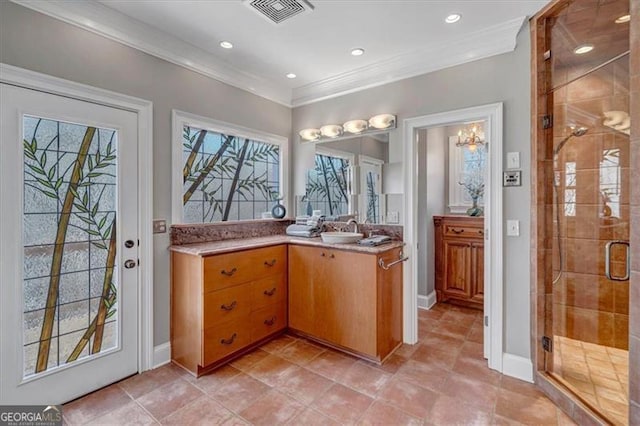 bathroom with vanity, baseboards, visible vents, ornamental molding, and a shower stall