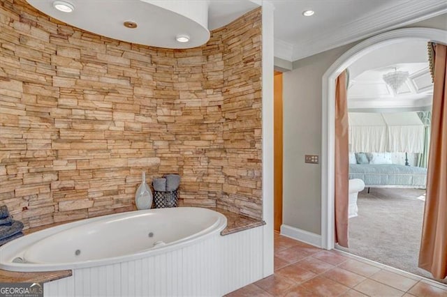 bathroom featuring tile patterned floors, a whirlpool tub, and ornamental molding