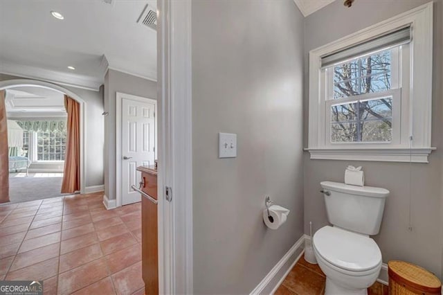 bathroom with visible vents, crown molding, baseboards, toilet, and tile patterned floors