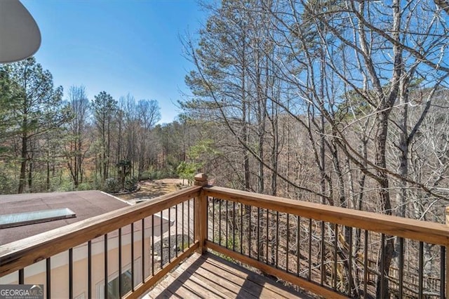 wooden deck with a wooded view