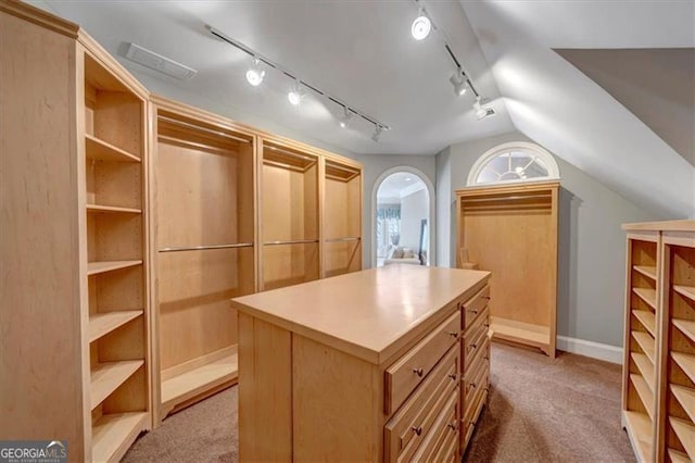 3460 Mansions Pkwy, Berkeley Lake, GA 30096 - walk in closet with light colored carpet, arched walkways, and lofted ceiling