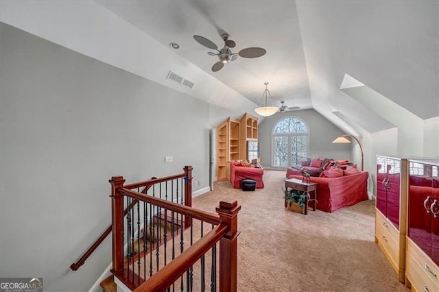 bonus room featuring visible vents, baseboards, lofted ceiling, carpet flooring, and a ceiling fan