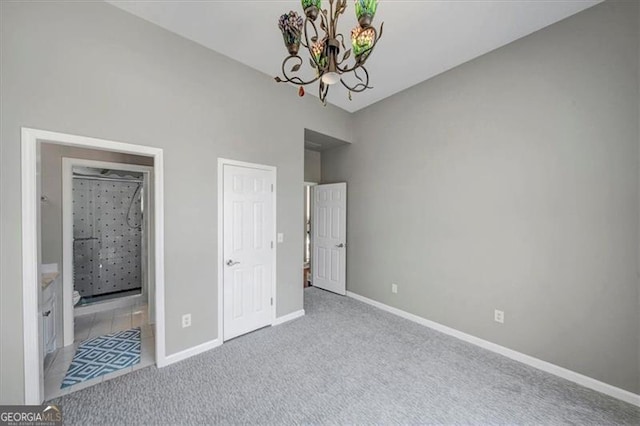 3460 Mansions Pkwy, Berkeley Lake, GA 30096 - unfurnished bedroom featuring a chandelier, carpet flooring, and connected bathroom