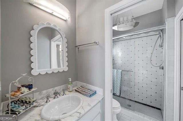 bathroom with vanity, a shower stall, toilet, and tile patterned flooring