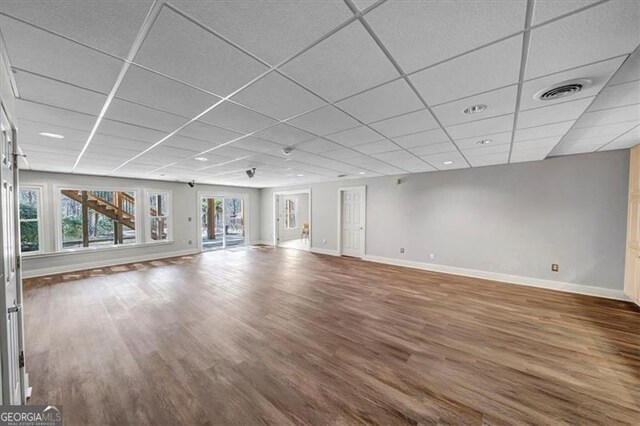 3460 Mansions Pkwy, Berkeley Lake, GA 30096 - unfurnished living room featuring a drop ceiling and wood finished floors