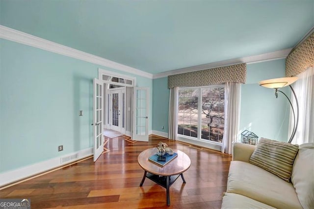 living area with visible vents, baseboards, ornamental molding, french doors, and wood finished floors