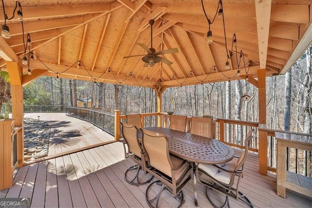 deck with a gazebo, outdoor dining area, and a ceiling fan