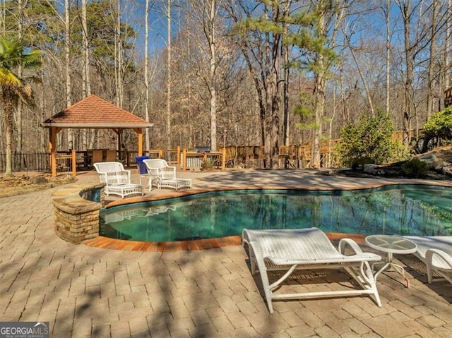 view of swimming pool featuring a gazebo, a patio area, and a fenced in pool