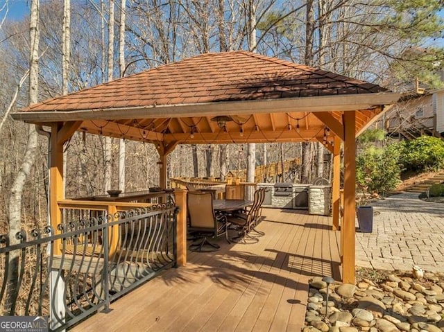 deck featuring a gazebo and outdoor dining area