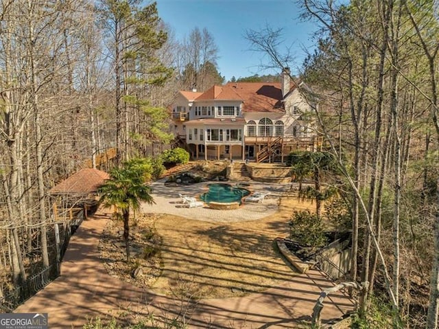 back of property featuring a wooden deck and a balcony