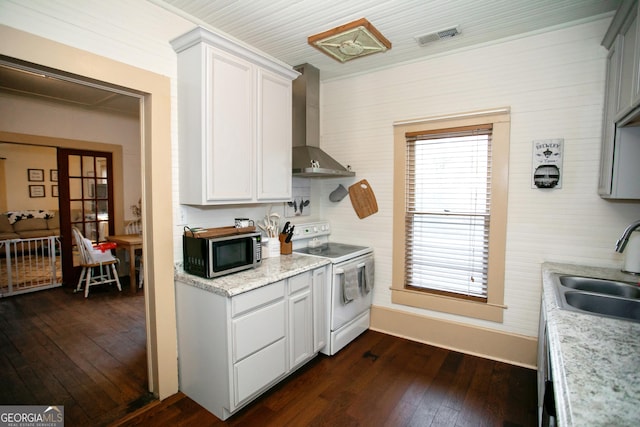 kitchen with white range with electric cooktop, stainless steel microwave, dark wood-type flooring, a sink, and wall chimney range hood