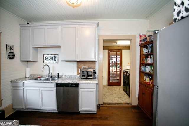 kitchen with dark wood-type flooring, light stone countertops, stainless steel appliances, white cabinetry, and a sink