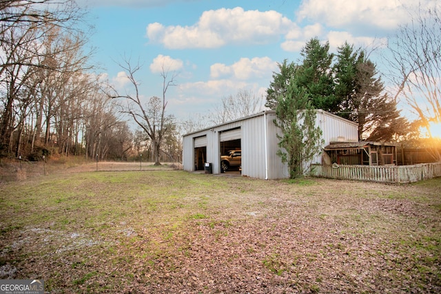 view of yard with an outbuilding, a pole building, and a detached garage