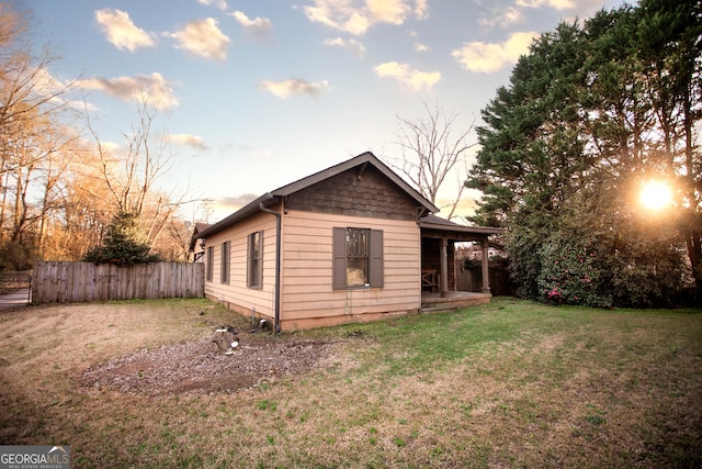 back of house with fence and a yard