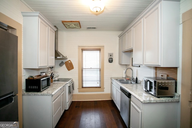 kitchen featuring stainless steel appliances, a sink, visible vents, wall chimney range hood, and dark wood-style floors