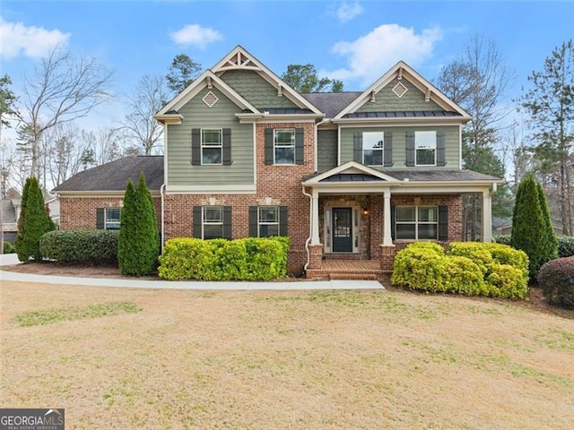 craftsman house with brick siding and a front lawn