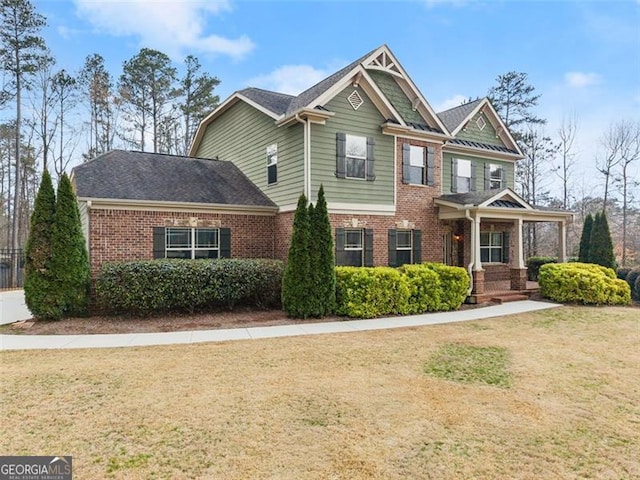 view of front facade with a front yard and brick siding