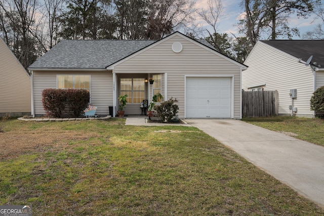 single story home with a garage, a shingled roof, concrete driveway, fence, and a front lawn