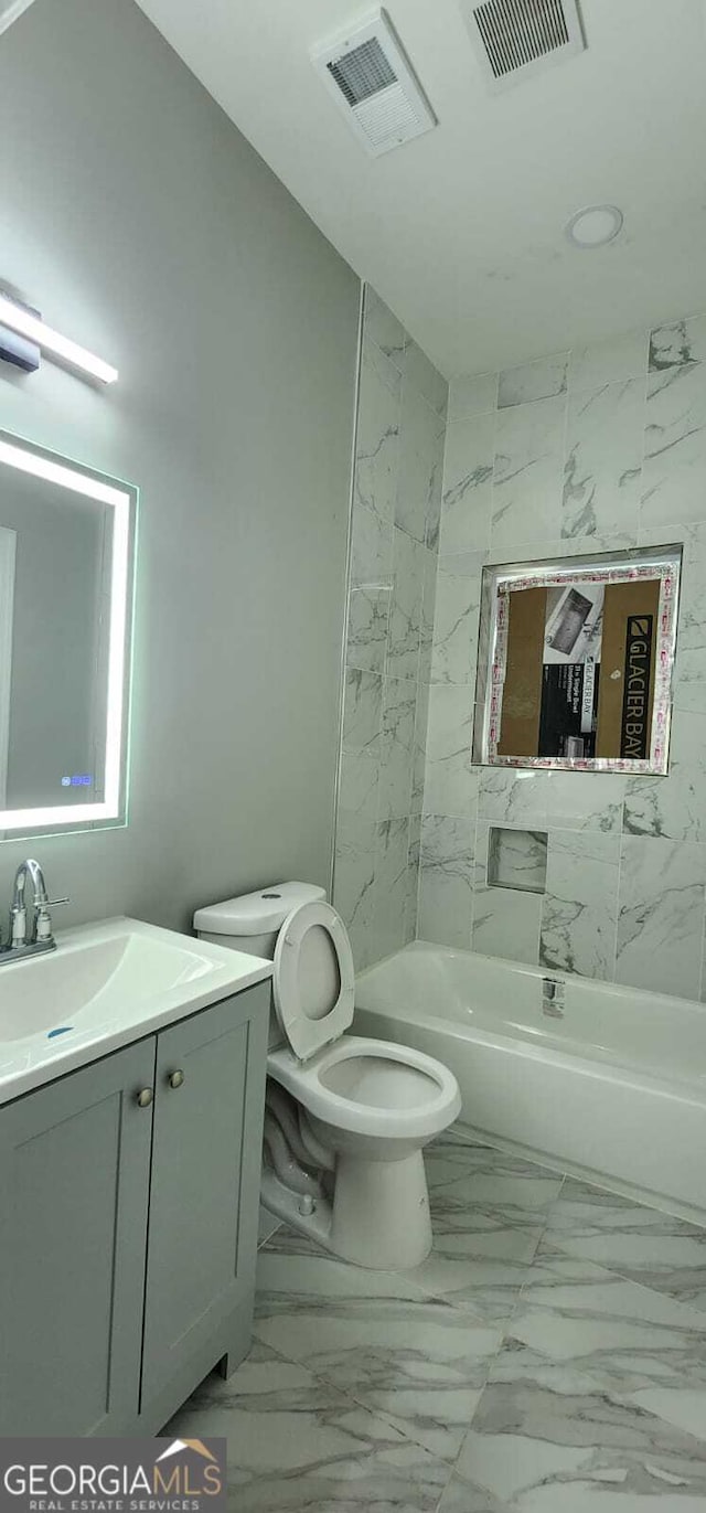 full bathroom with toilet, marble finish floor, and visible vents