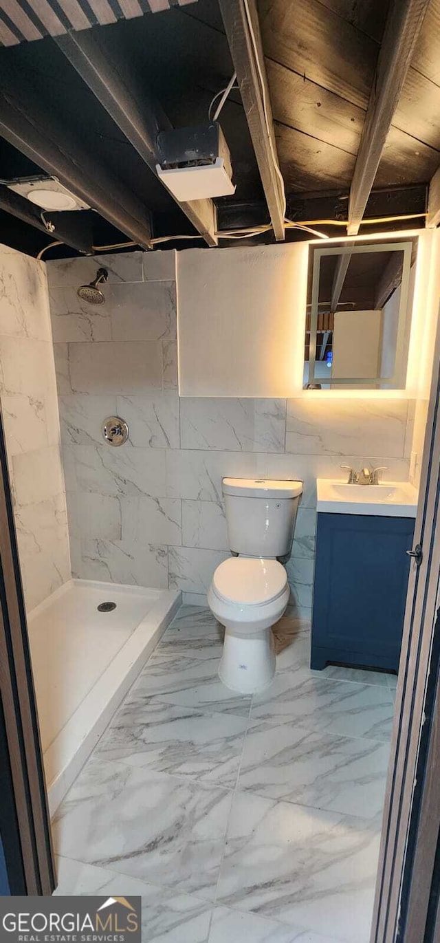 full bathroom with marble finish floor, a shower stall, toilet, and vanity