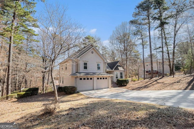 view of side of home with a garage and concrete driveway