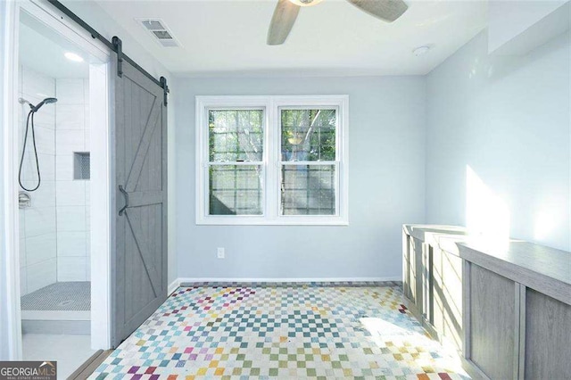 bathroom featuring tile patterned floors, visible vents, baseboards, and tiled shower