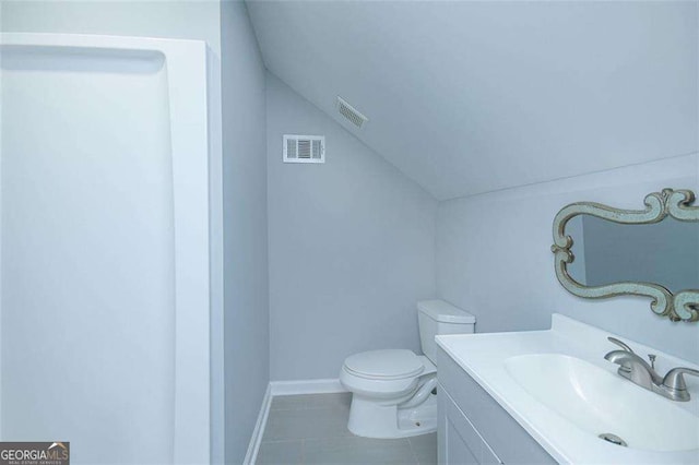 bathroom with visible vents, lofted ceiling, toilet, and vanity