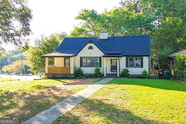 view of front of house with a front yard, fence, and a chimney